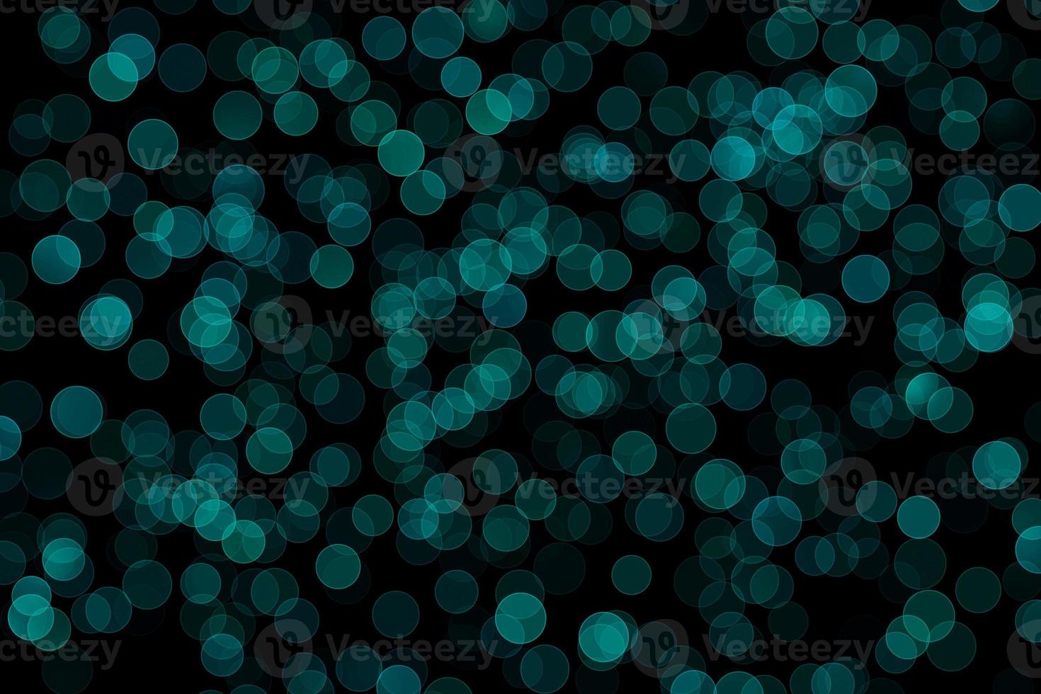 sea blue blur effect black background.abstract black unfocused blur light dots black . photo