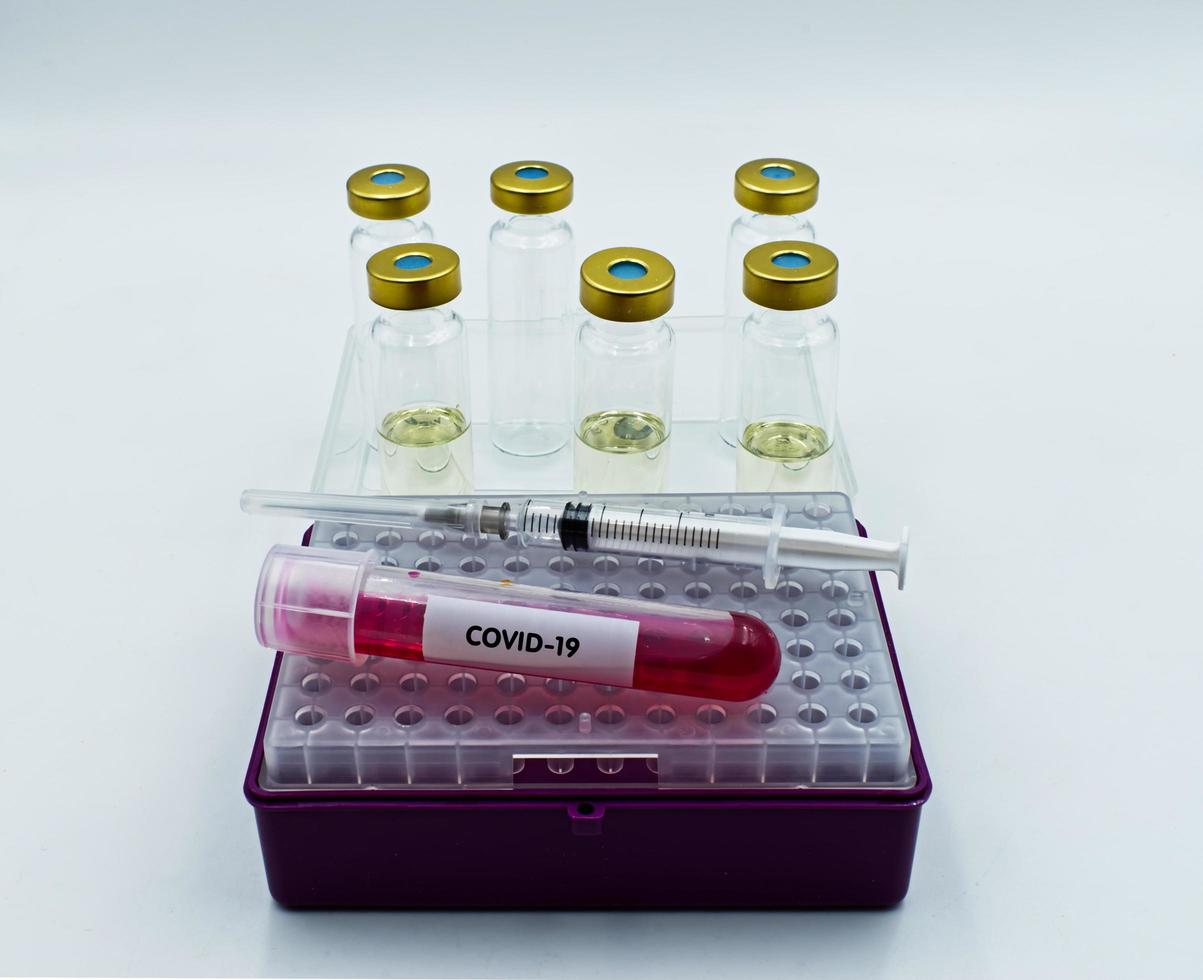 Syringe injection, infected blood sample and vaccine samples Covid 19. photo