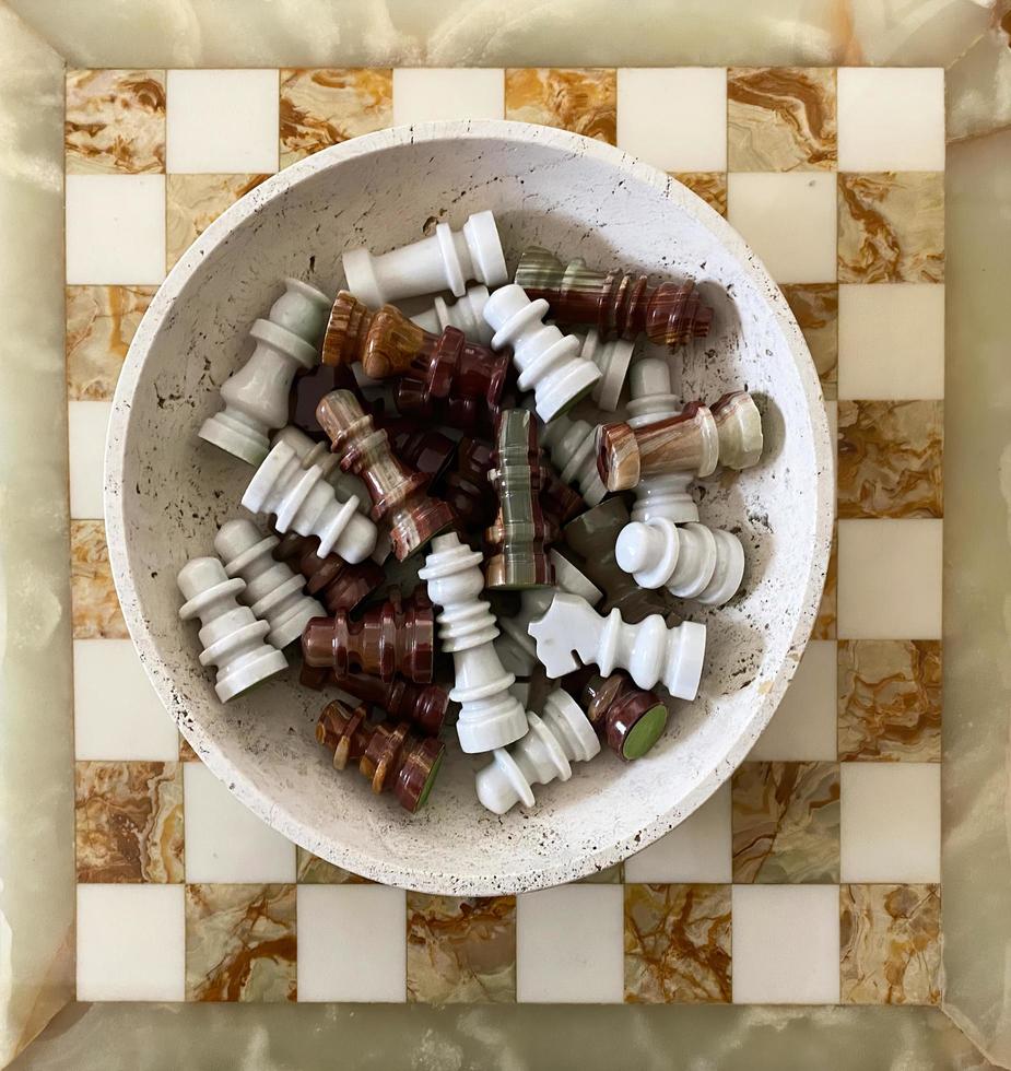 Antique Carrara marble chessboard and pieces. Italy. Marble board game. Top view photo