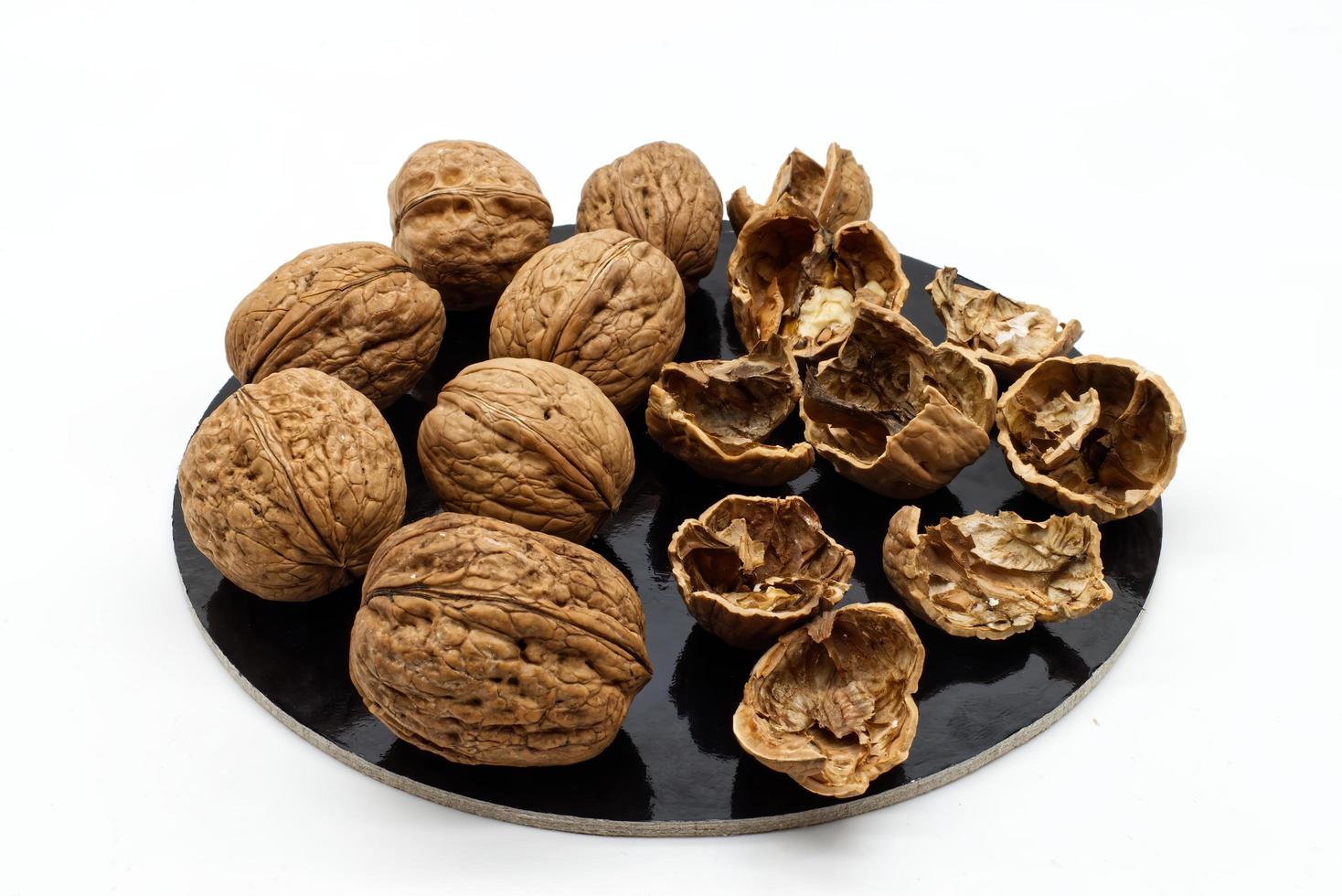 Many whole organic walnuts and next walnuts out of their shell photo