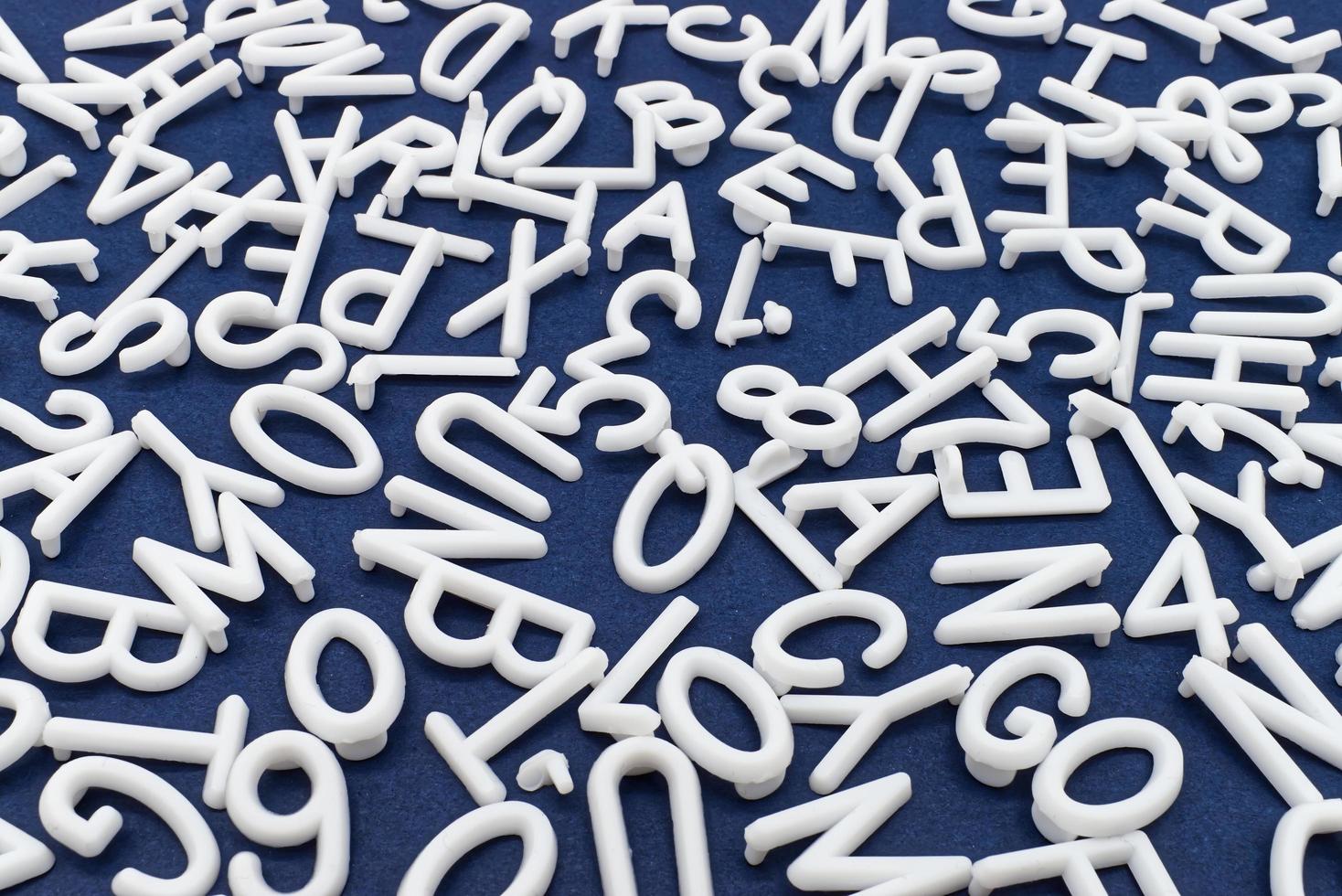 White letter and number are scattered chaotically on a table photo