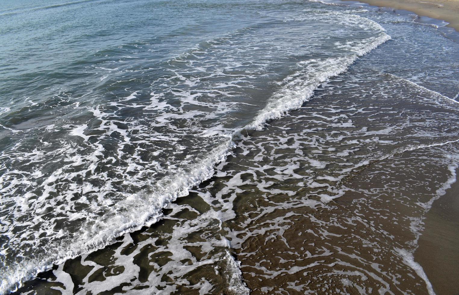 Sea waves crushing on shore. White sea foam. photo