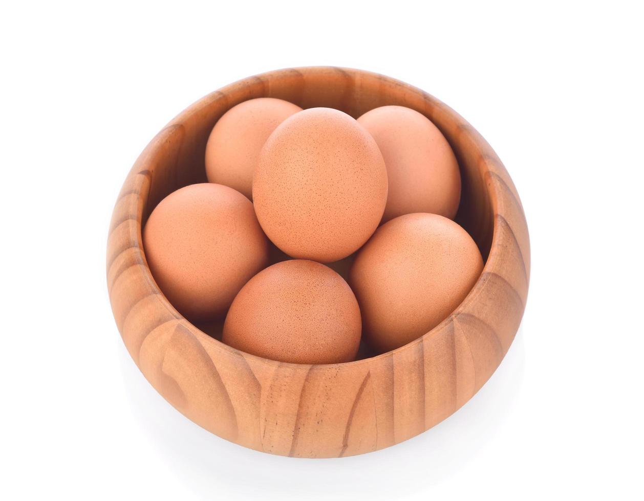 egg in a wooden bowl isolated on white background photo