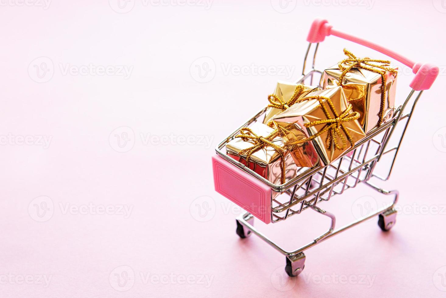 Shopping cart with gift boxes photo