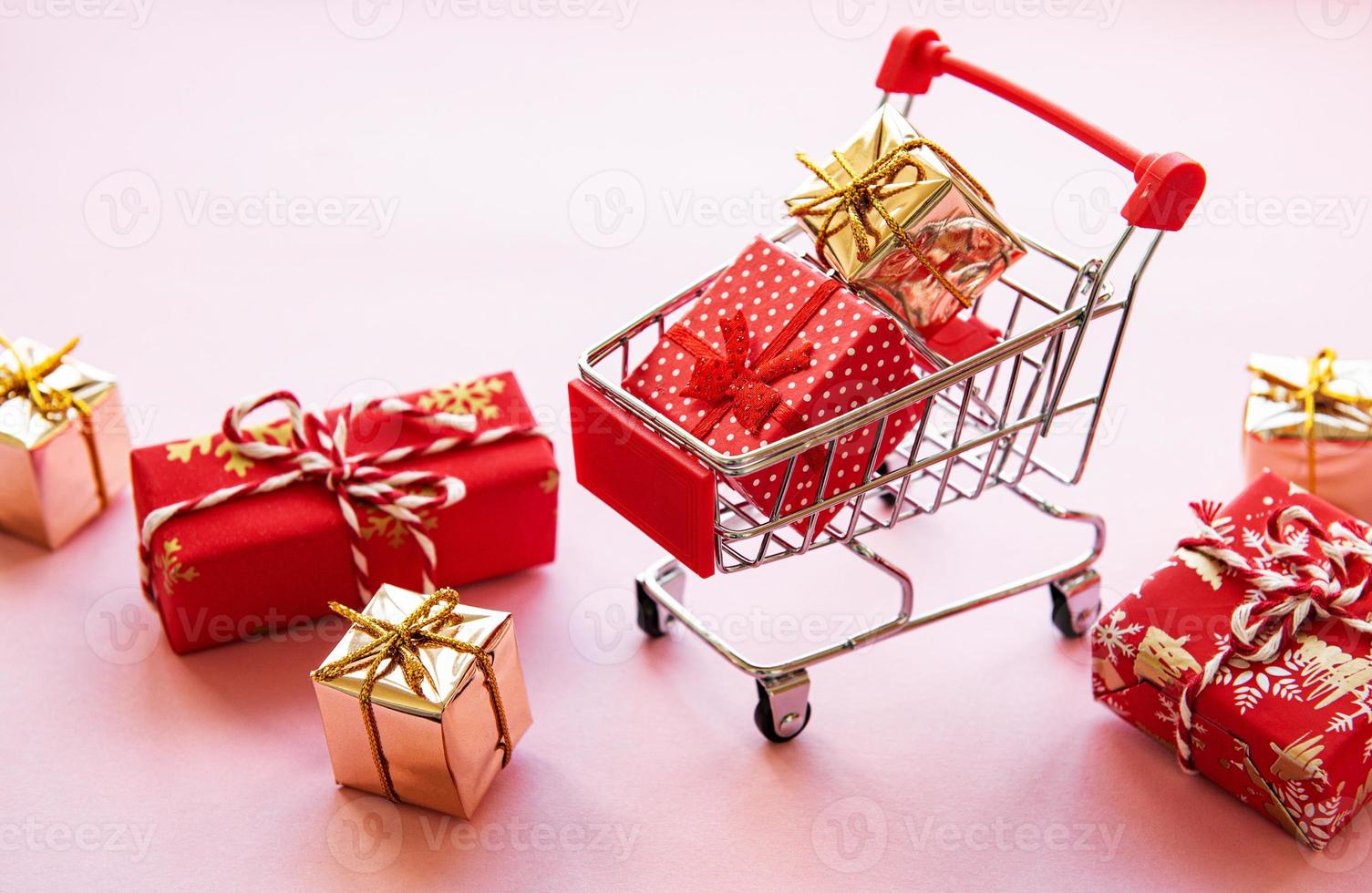 Shopping cart with gift boxes photo