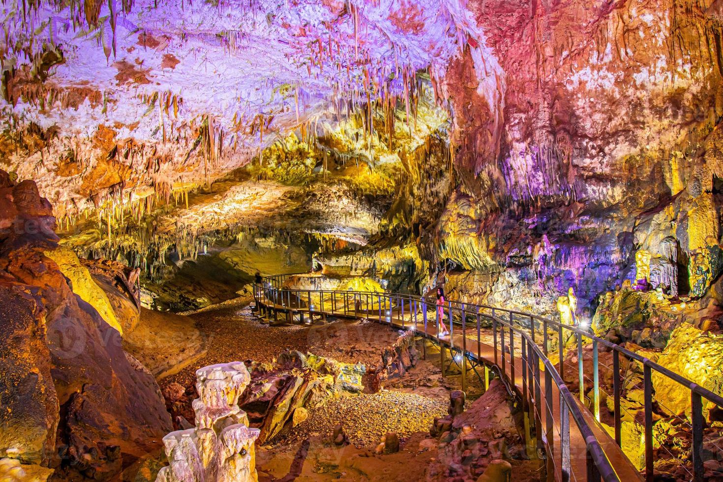 Pathway in Prometheus cave with beautiful colorful structures and formations photo
