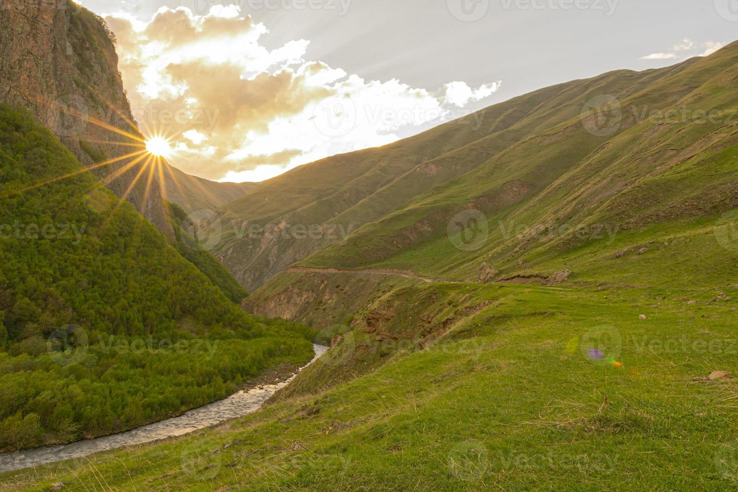 sunburst over mountains photo