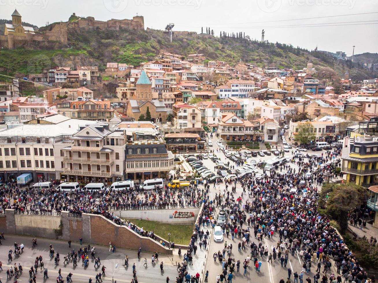 People walking in streets in Georgia capital. Aerial view Tbilisi tragedy anniversary demonstration. photo