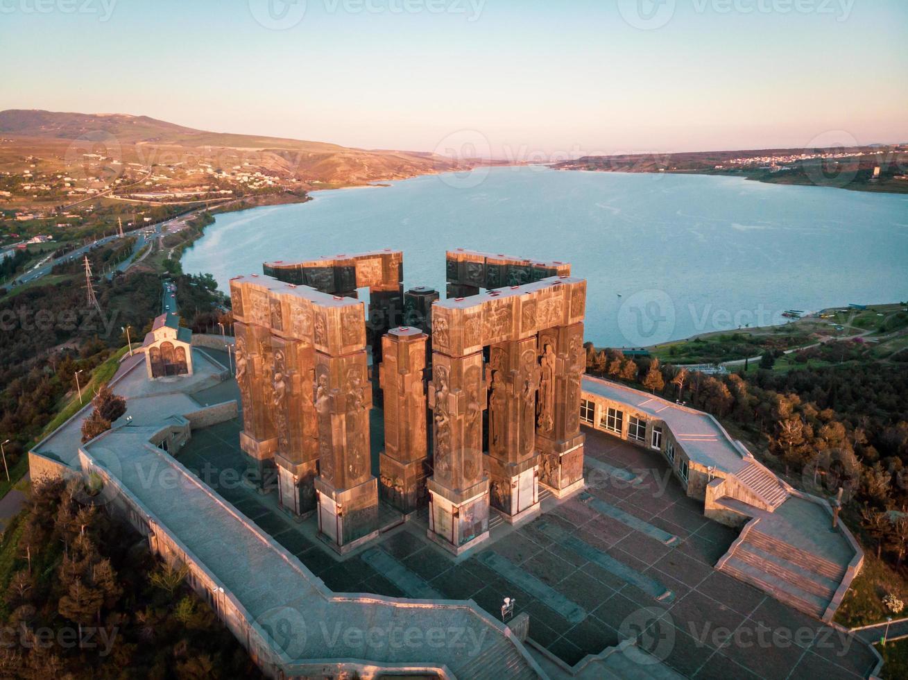 Aerial view down to monument of Chronicles of Georgia in Sakartvelo with Tbilisi sea lake in the background. Sightseeing and tourist sites in Caucasus.Tbilisi Georgia. 2020 photo