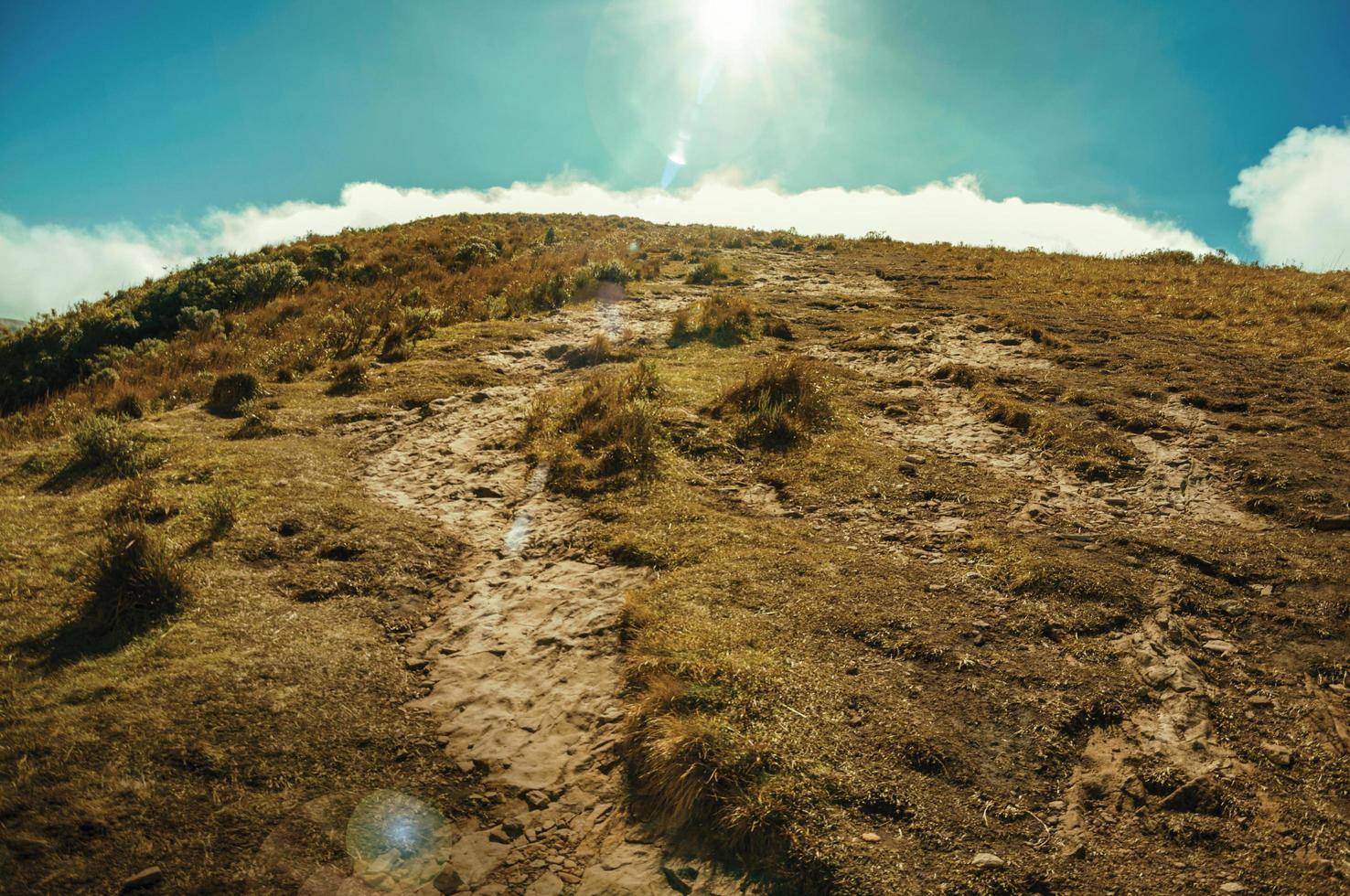 Rocky trail going up to the top of cliff at Fortaleza Canyon, in a sunny day near Cambara do Sul. A small country town in southern Brazil with amazing natural tourist attractions. Retouched photo. photo