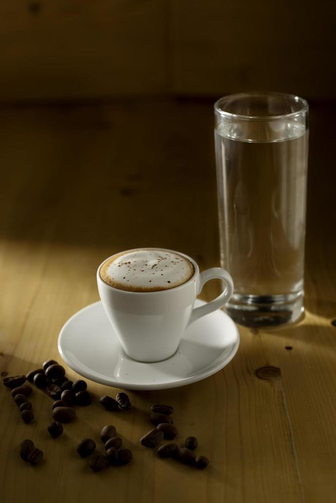 Coffee Cup and Beans on Wooden Table photo