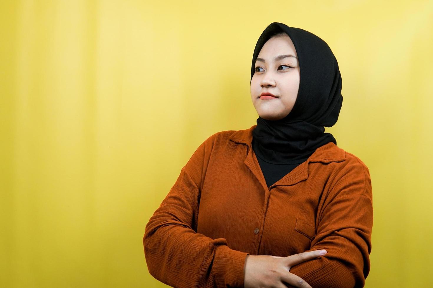 Beautiful young asian muslim woman thinking, facing empty space isolated photo