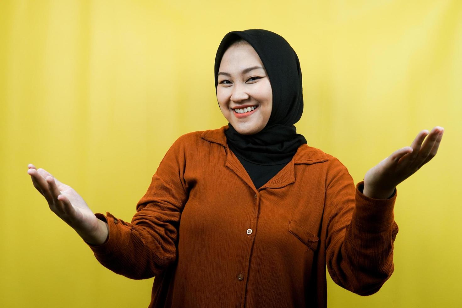 Beautiful young asian muslim woman with open arms to camera, welcome sign hand, hand sign wanting to hug, smiling cheerfully, isolated photo