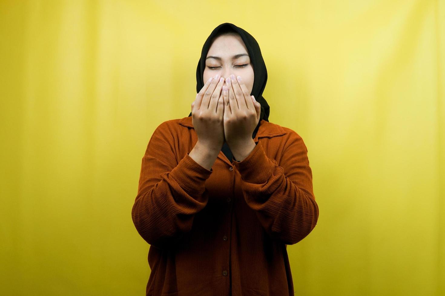 Beautiful young asian muslim woman praying, with open arms, isolated photo