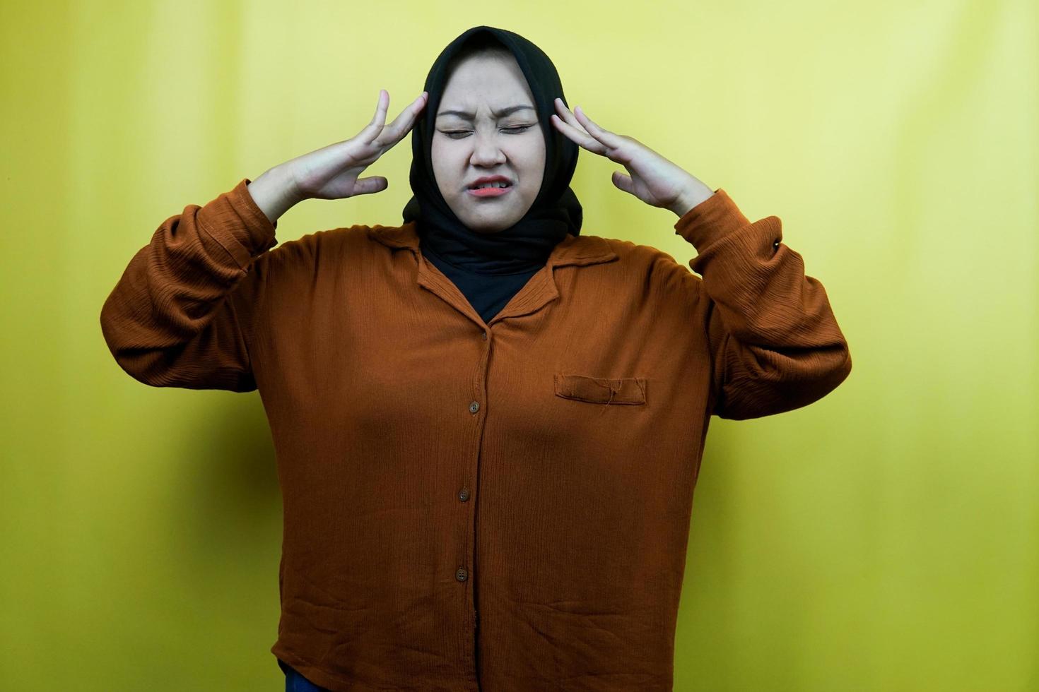 Beautiful young asian muslim woman stress, panic, shock isolated photo