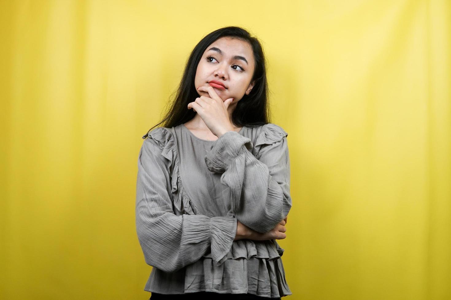 Beautiful young woman thinking, looking at empty space, looking for ideas isolated photo