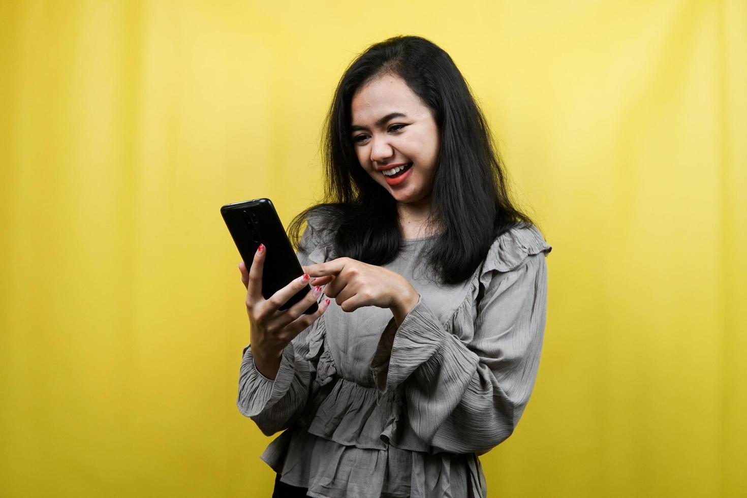 Beautiful young woman with hands holding smartphone, promoting product, presenting something, advertisement, isolated photo