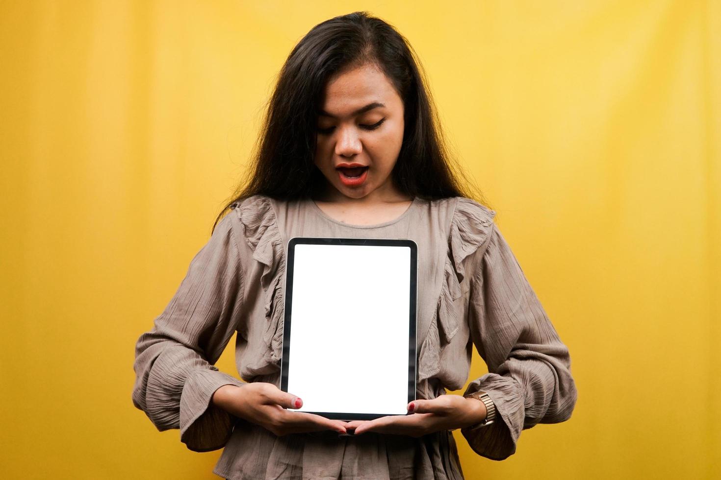 Beautiful young woman hands holding tablet with blank or white screen, presenting something, promoting product, cheerful and confident, advertisement, isolated photo