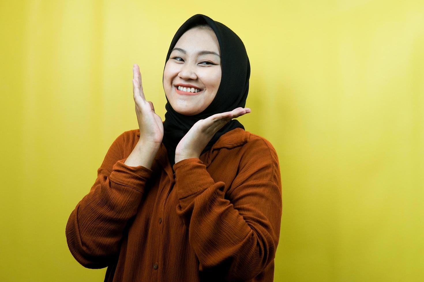 Beautiful young asian muslim woman with hands V sign on chin, smiling confident, enthusiastic and cheerful, isolated photo