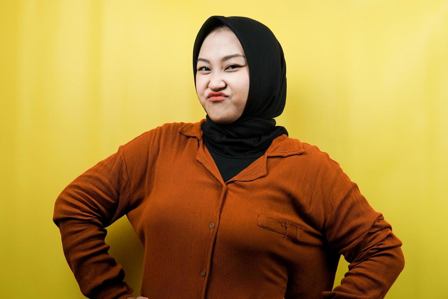 Beautiful young asian muslim woman angry, pouting, feeling annoyed, dissatisfied, uncomfortable, feeling bullied, lied to, looking at camera isolated photo