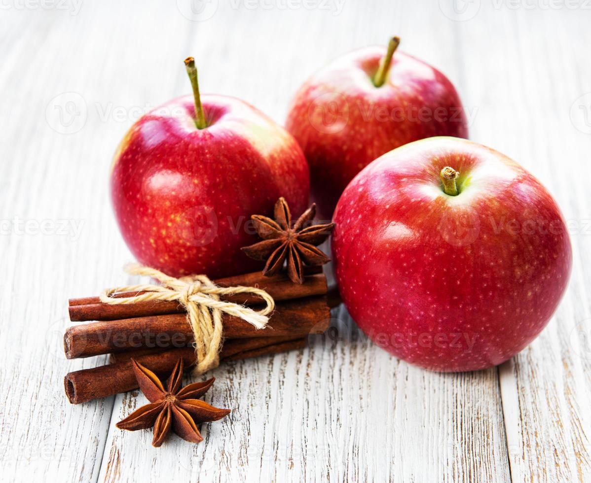 Red apples with cinnamon sticks and anise photo