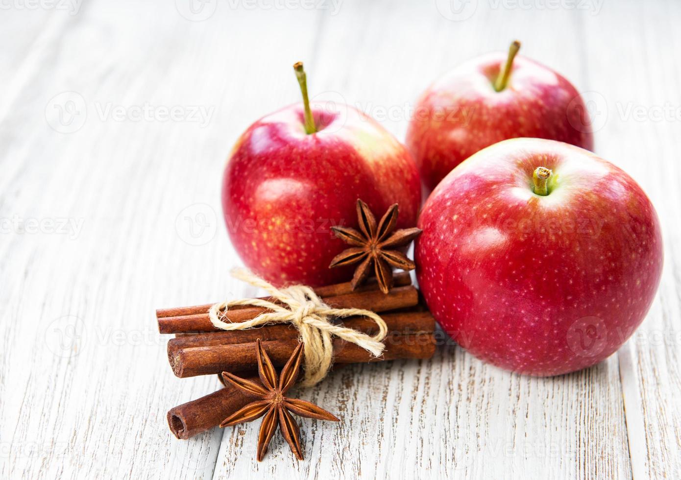 Red apples with cinnamon sticks and anise photo