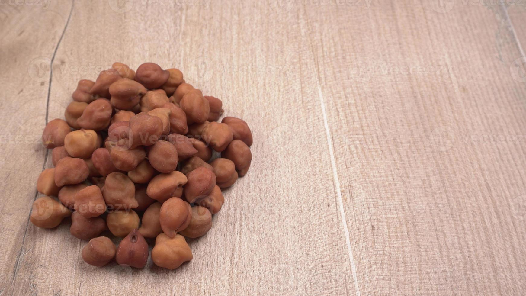 Black Chickpeas or Kala Chana with chana dal pulse isolated on wooden Background. photo