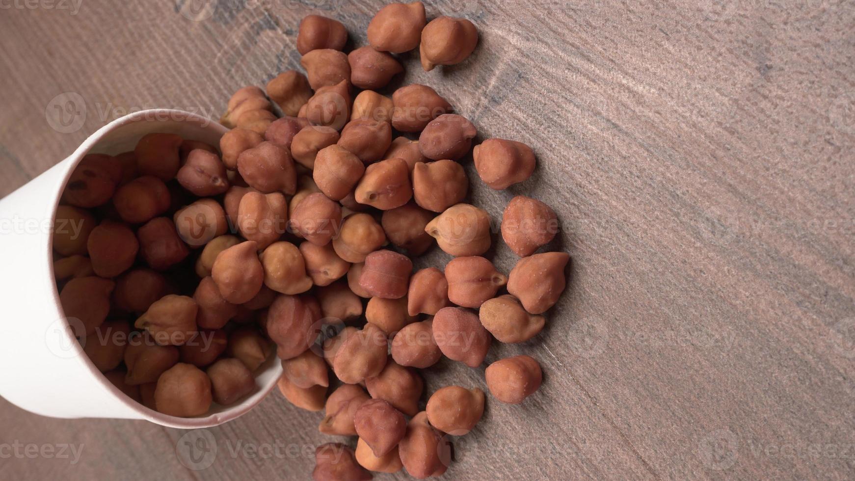 Black Chickpeas or Kala Chana with chana dal pulse isolated on wooden Background. photo