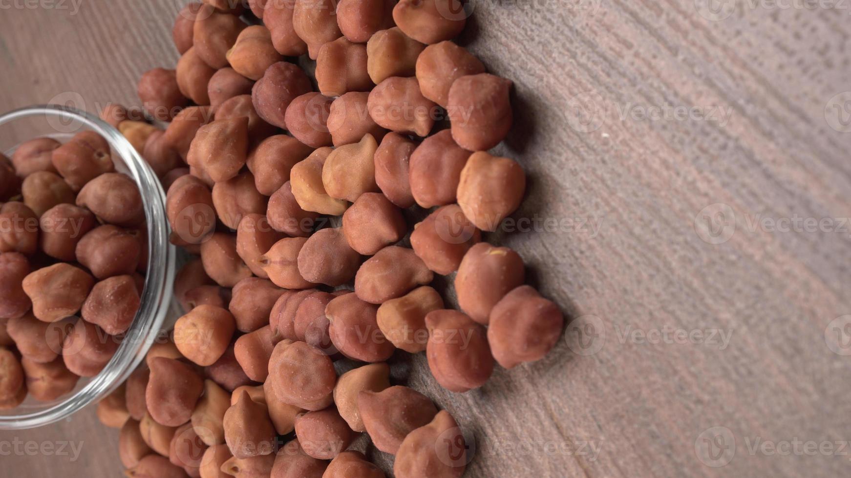 Black Chickpeas or Kala Chana with chana dal pulse isolated on wooden Background. photo