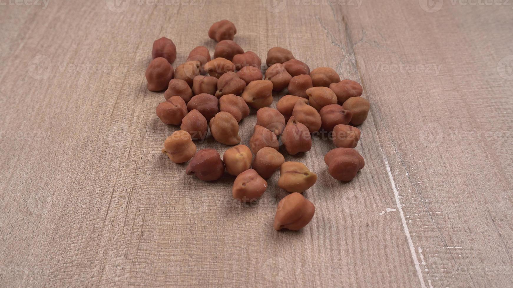 Black Chickpeas or Kala Chana with chana dal pulse isolated on wooden Background. photo