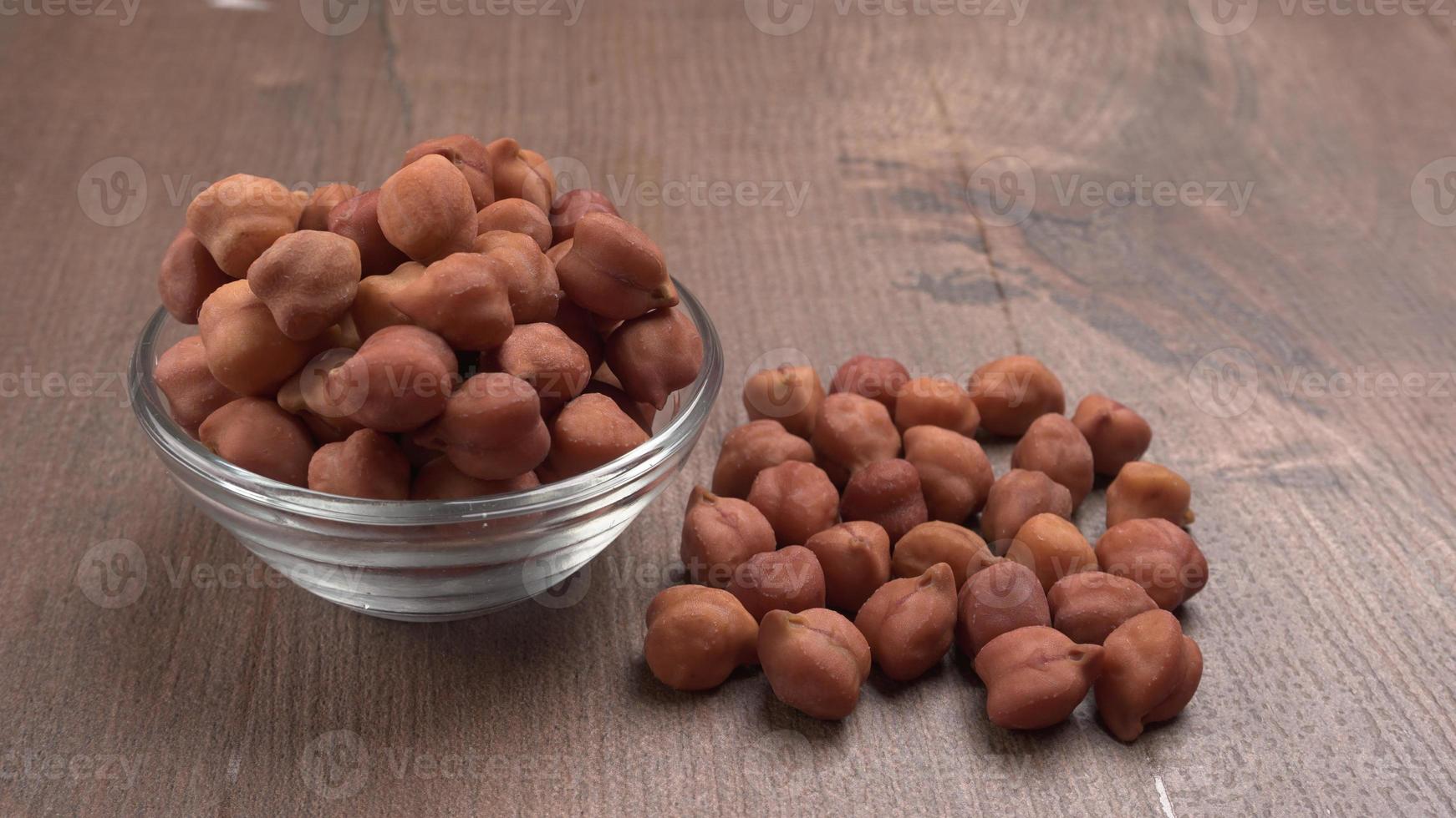 Black Chickpeas or Kala Chana with chana dal pulse isolated on wooden Background. photo