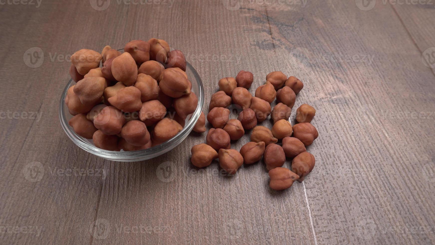 Black Chickpeas or Kala Chana with chana dal pulse isolated on wooden Background. photo