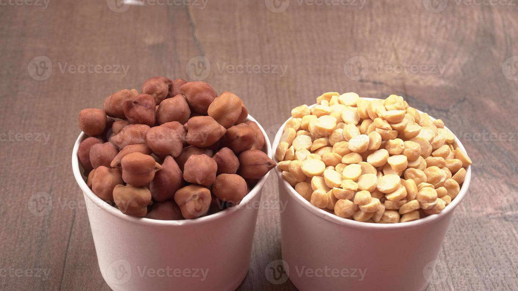Black Chickpeas or Kala Chana with chana dal pulse isolated on wooden Background. photo