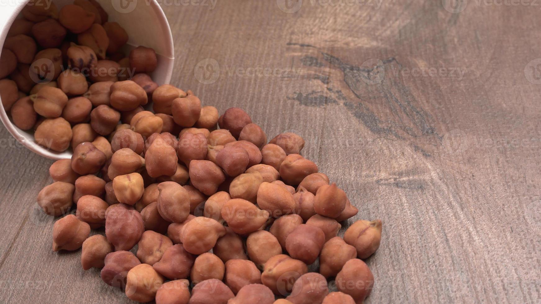 Black Chickpeas or Kala Chana with chana dal pulse isolated on wooden Background. photo