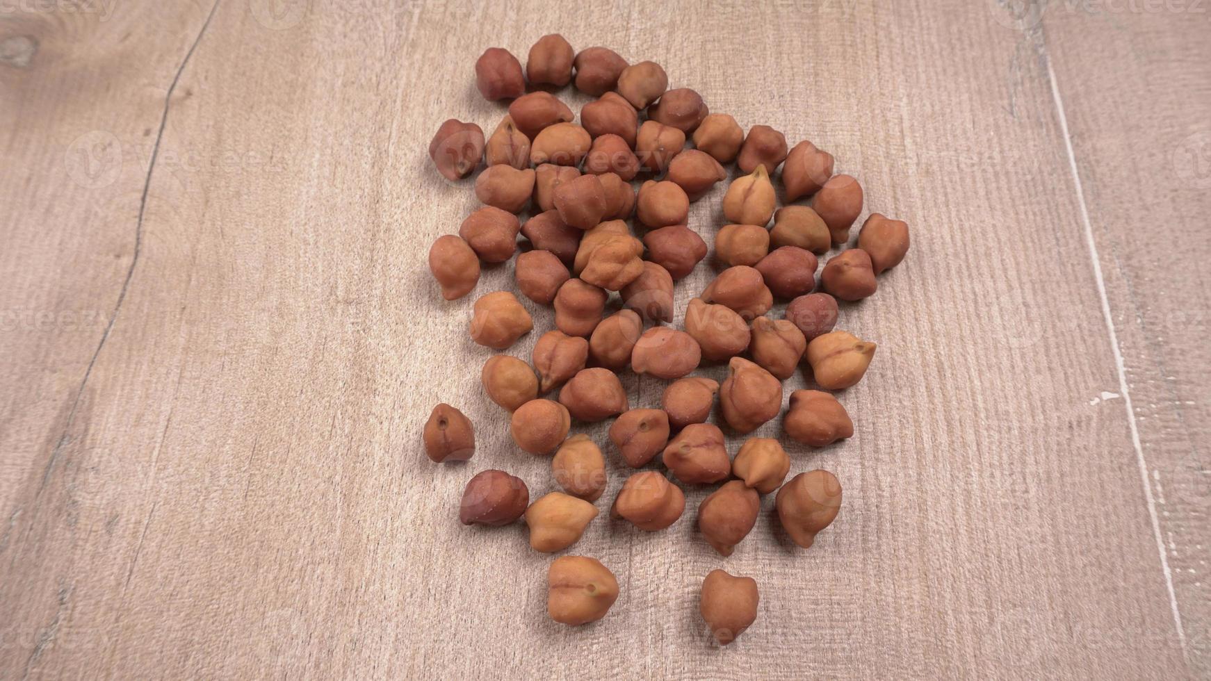 Black Chickpeas or Kala Chana with chana dal pulse isolated on wooden Background. photo