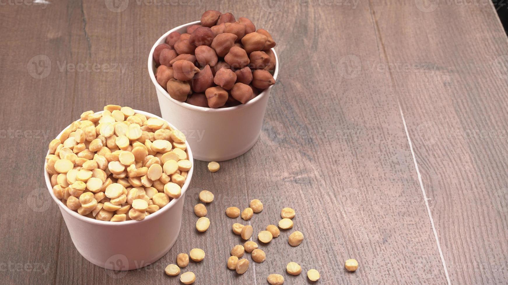 Black Chickpeas or Kala Chana with chana dal pulse isolated on wooden Background. photo