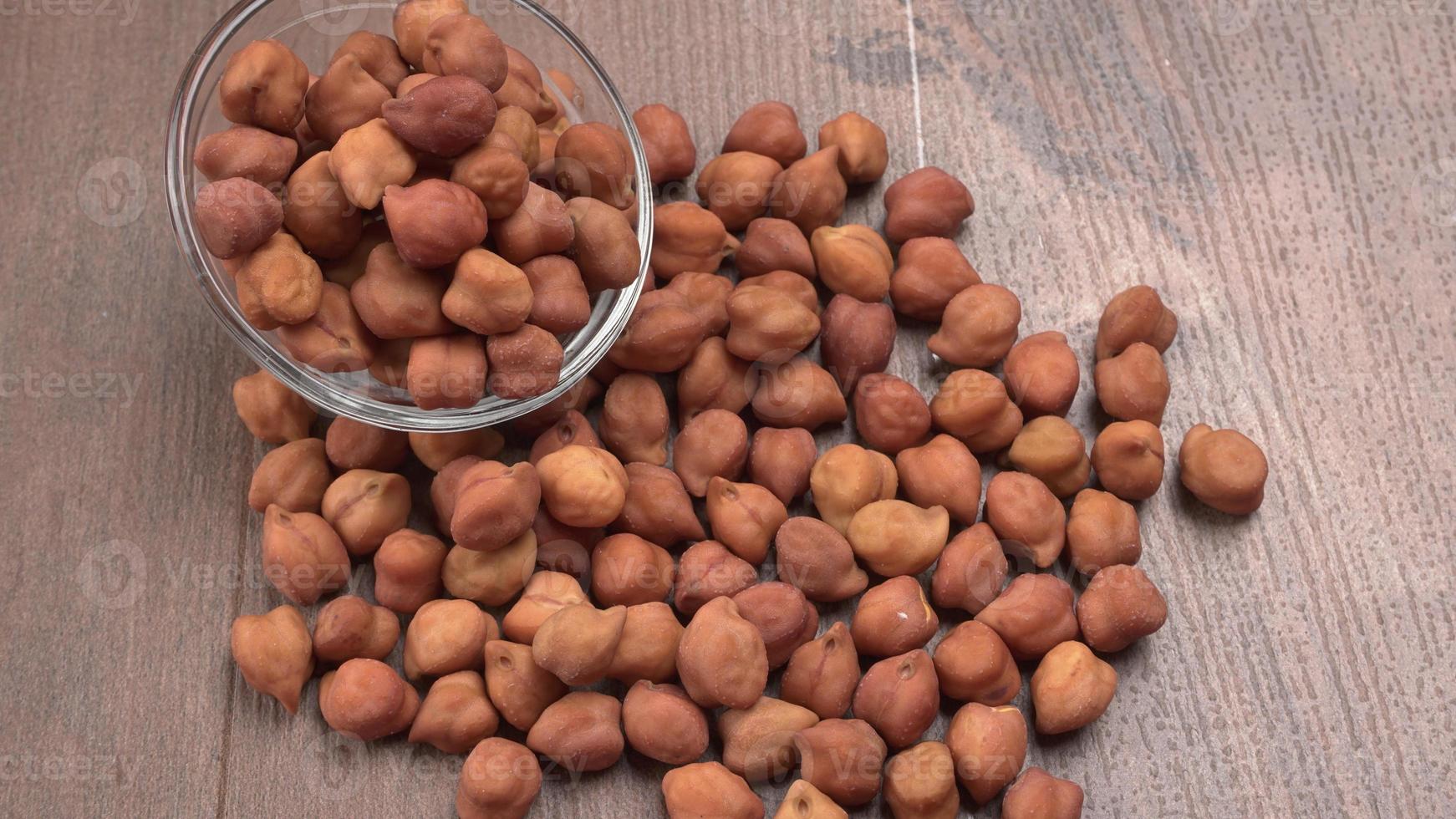 Black Chickpeas or Kala Chana with chana dal pulse isolated on wooden Background. photo