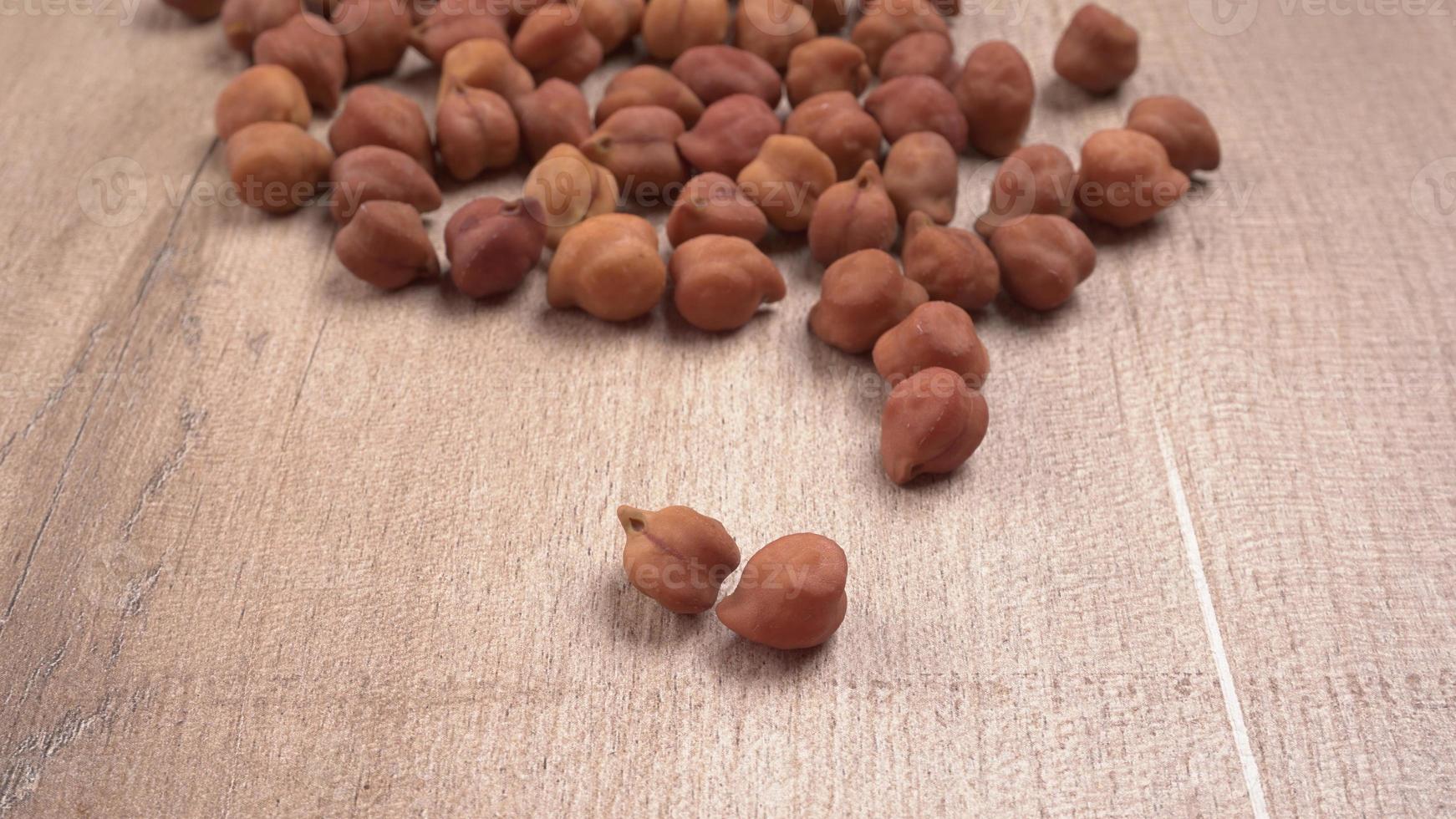 Black Chickpeas or Kala Chana with chana dal pulse isolated on wooden Background. photo