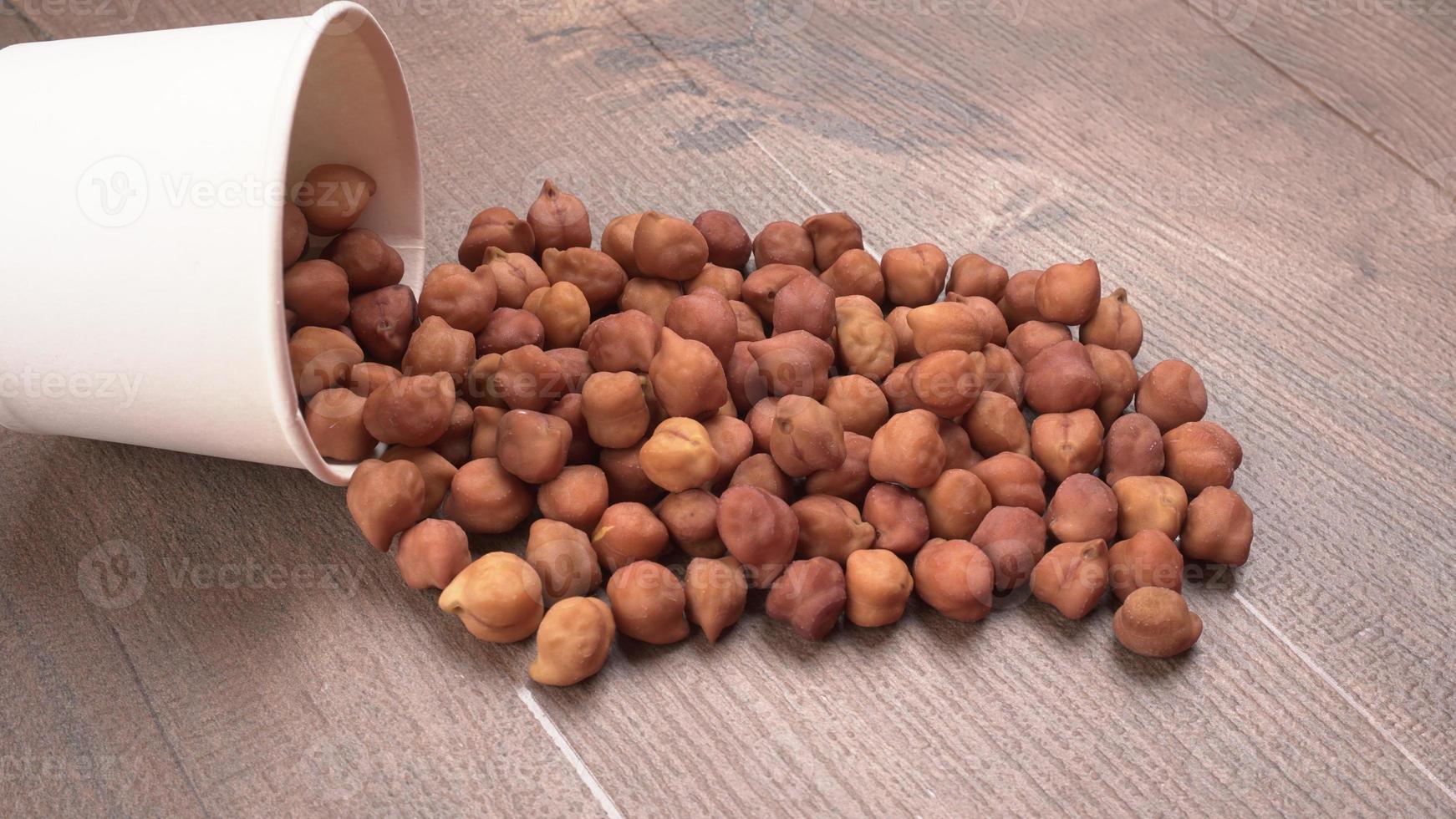 Black Chickpeas or Kala Chana with chana dal pulse isolated on wooden Background. photo