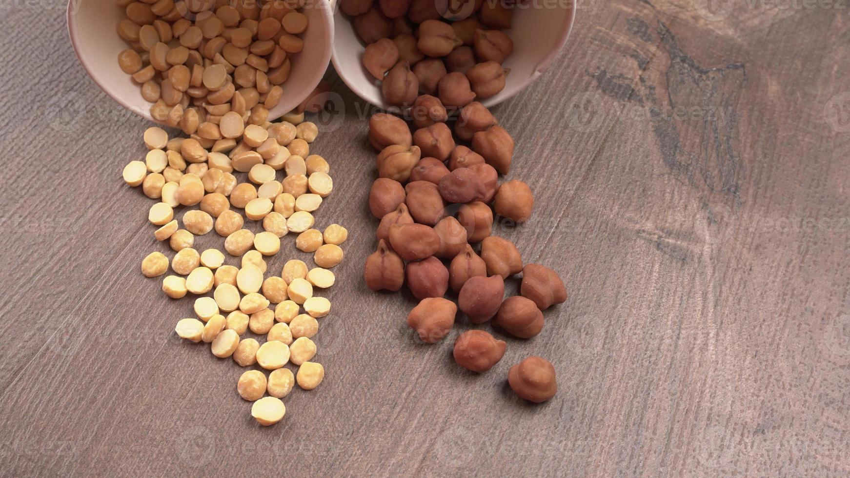 Black Chickpeas or Kala Chana with chana dal pulse isolated on wooden Background. photo