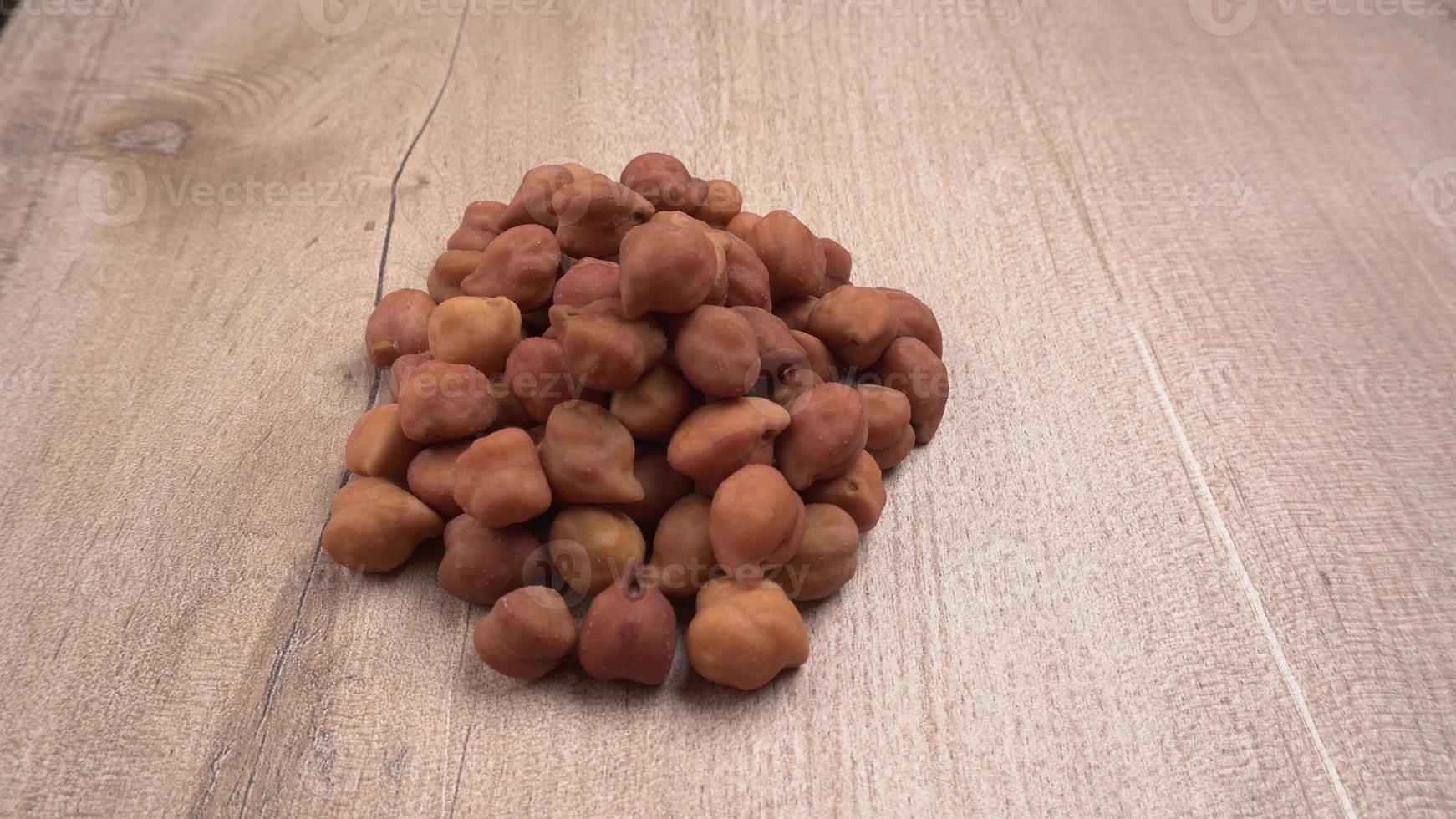 Black Chickpeas or Kala Chana with chana dal pulse isolated on wooden Background. photo