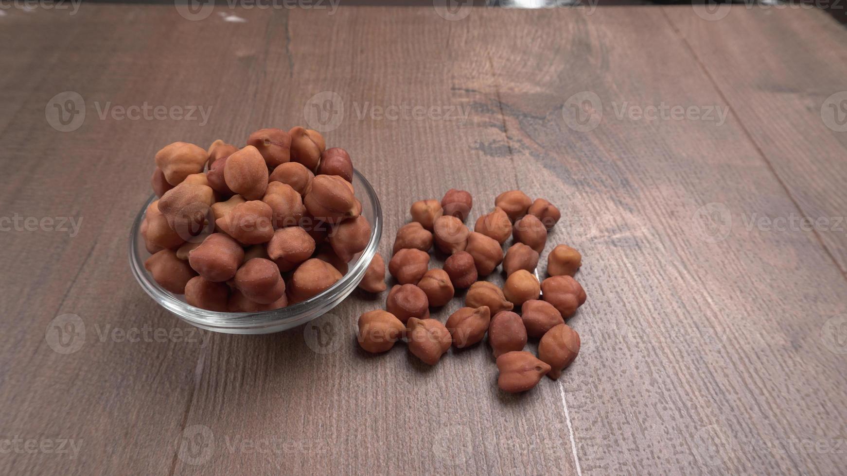 Black Chickpeas or Kala Chana with chana dal pulse isolated on wooden Background. photo