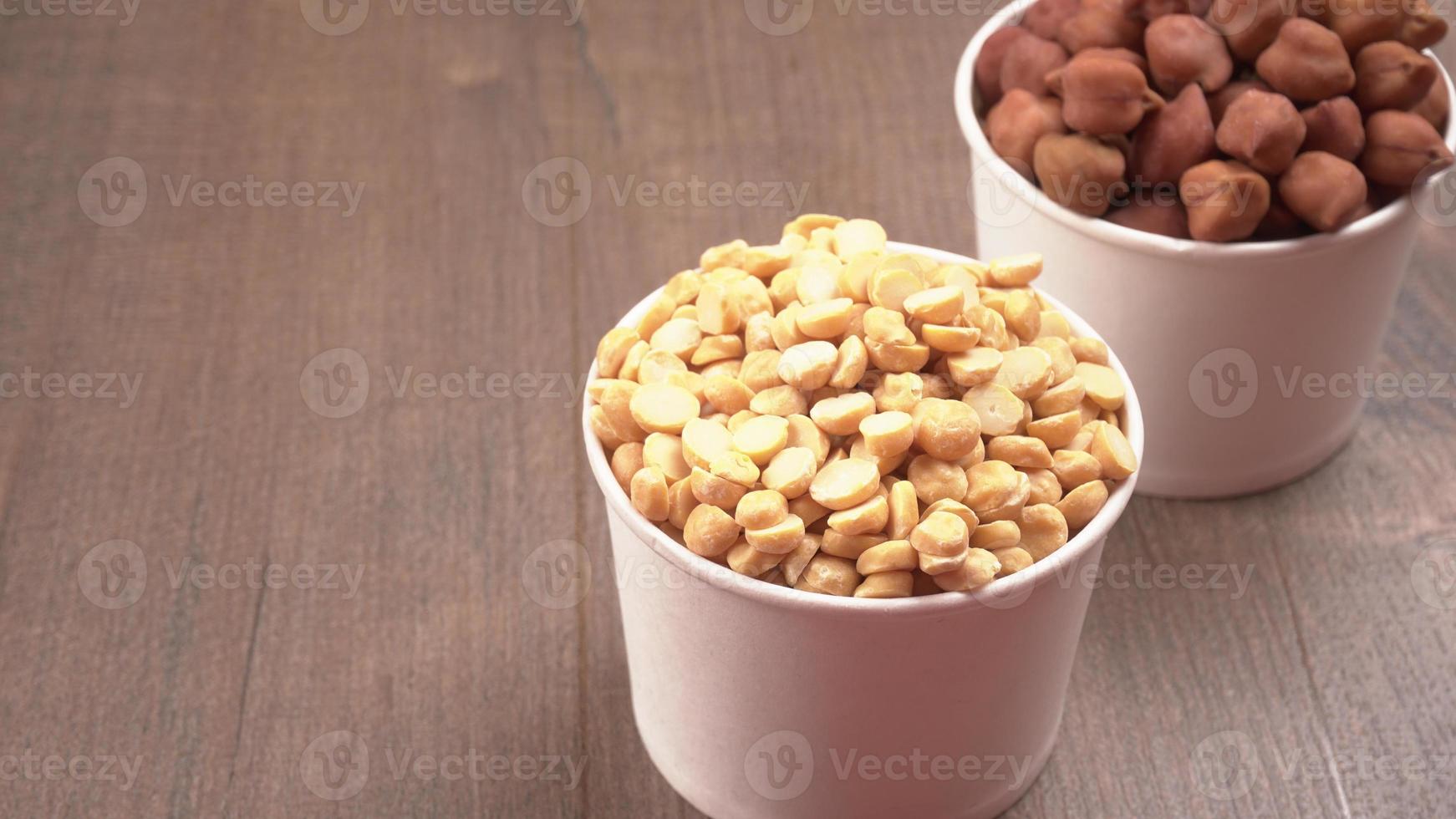 Black Chickpeas or Kala Chana with chana dal pulse isolated on wooden Background. photo