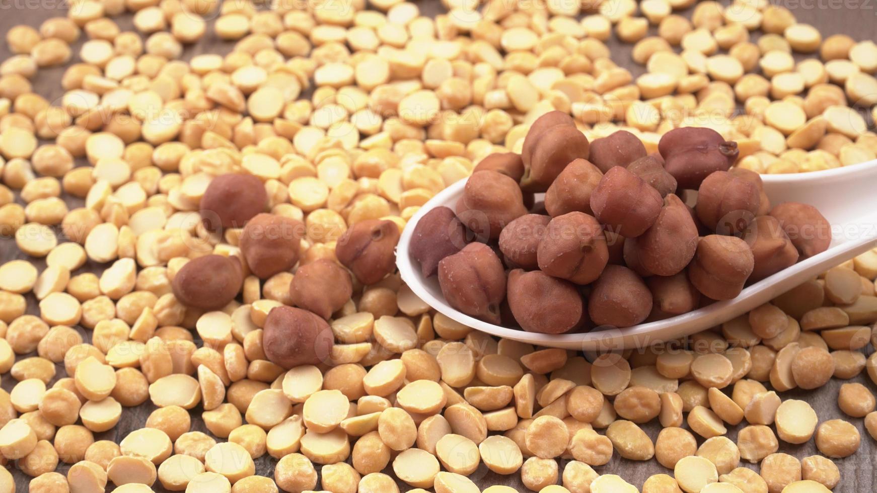 Black Chickpeas or Kala Chana with chana dal pulse isolated on wooden Background. photo