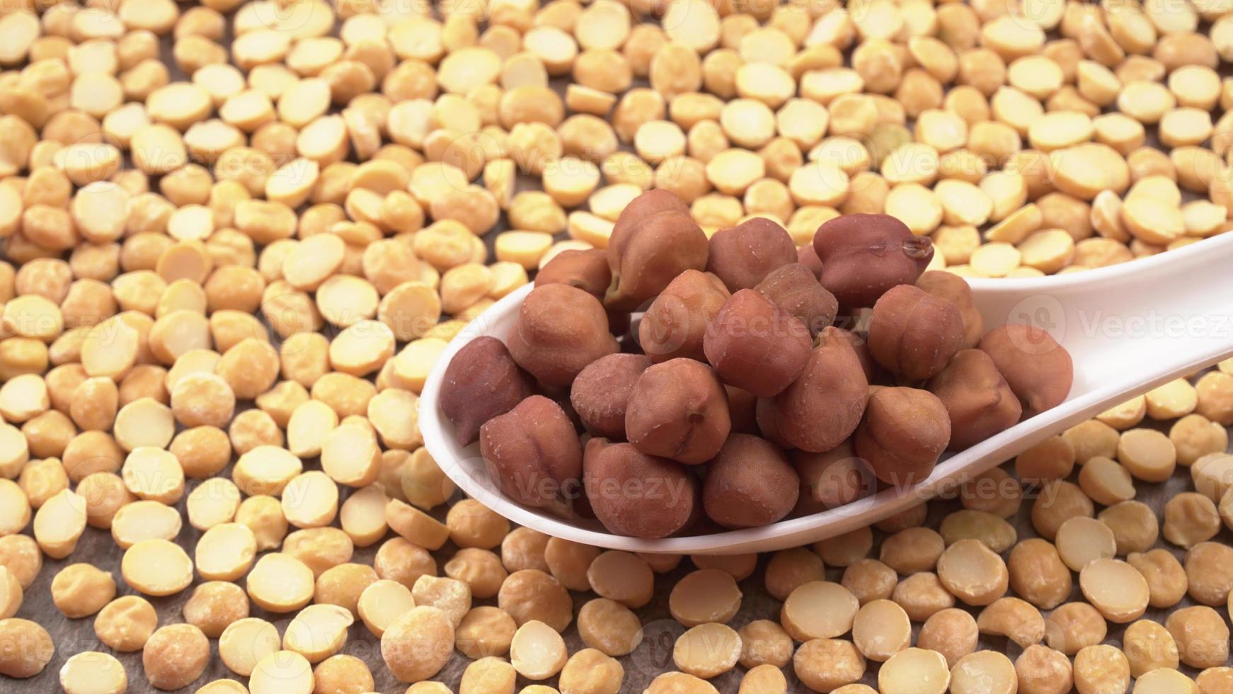 Black Chickpeas or Kala Chana with chana dal pulse isolated on wooden Background. photo