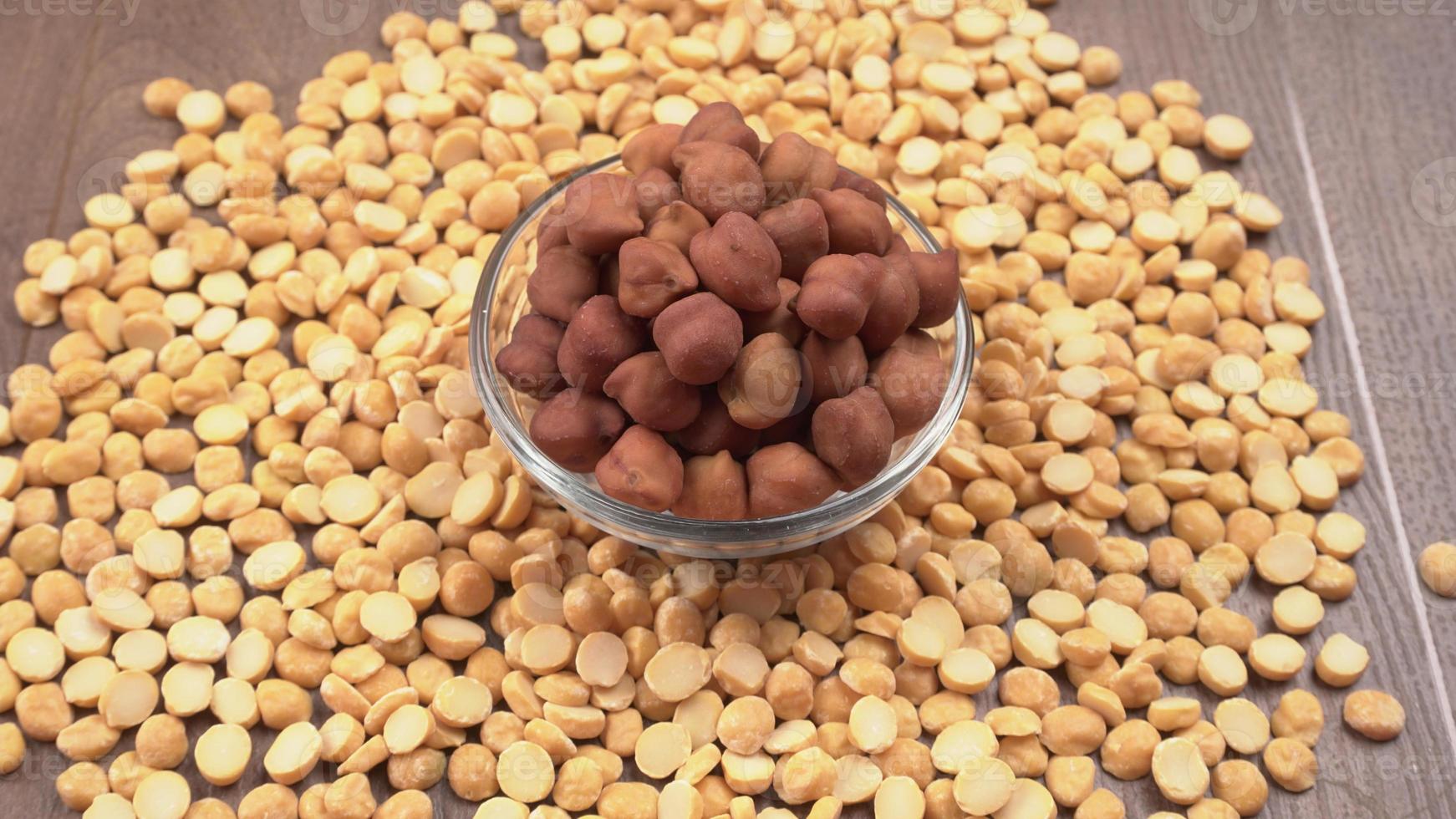Black Chickpeas or Kala Chana with chana dal pulse isolated on wooden Background. photo