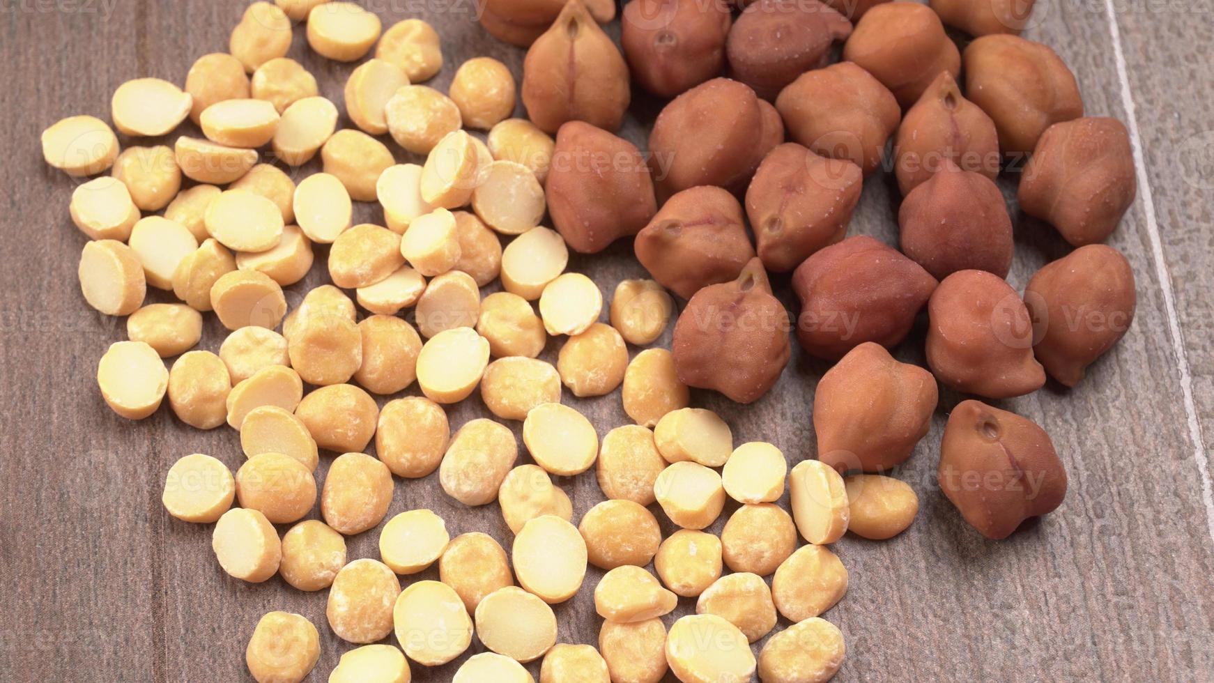 Black Chickpeas or Kala Chana with chana dal pulse isolated on wooden Background. photo
