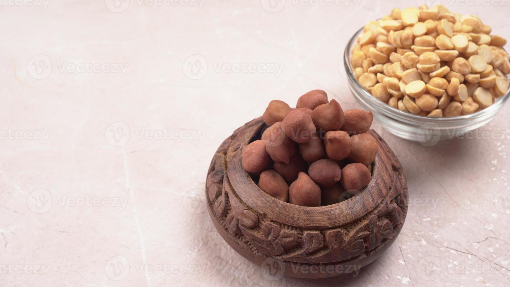 Black Chickpeas or Kala Chana with chana dal pulse isolated on wooden Background. photo