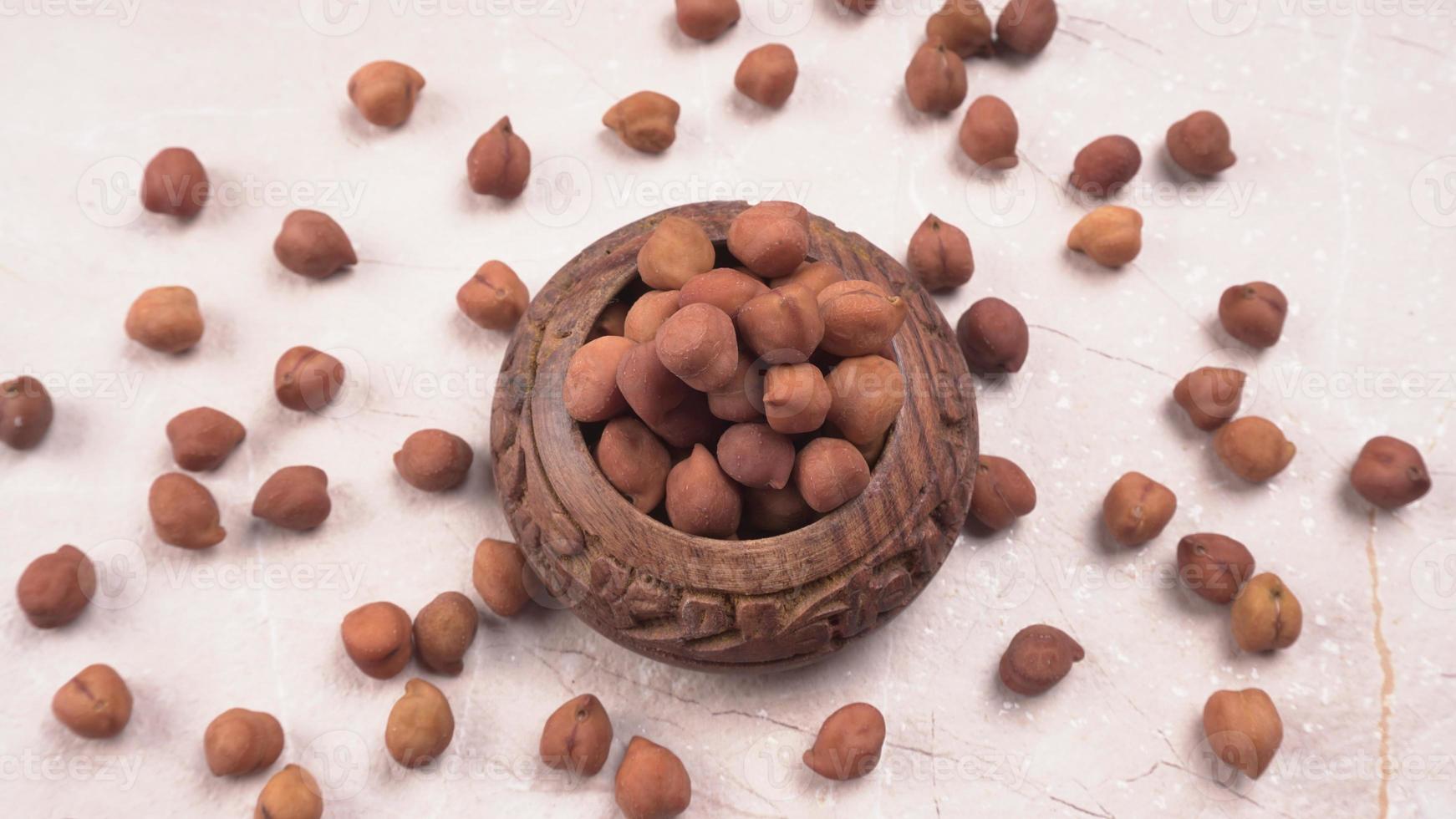 Black Chickpeas or Kala Chana with chana dal pulse isolated on wooden Background. photo