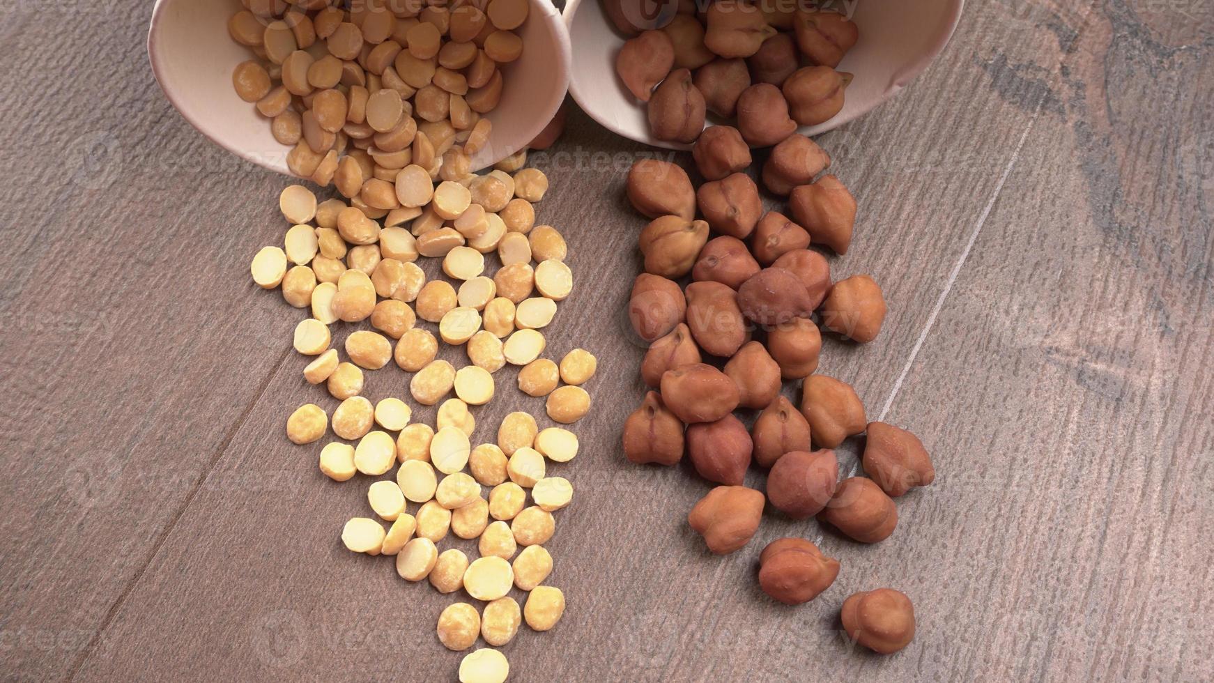 Black Chickpeas or Kala Chana with chana dal pulse isolated on wooden Background. photo